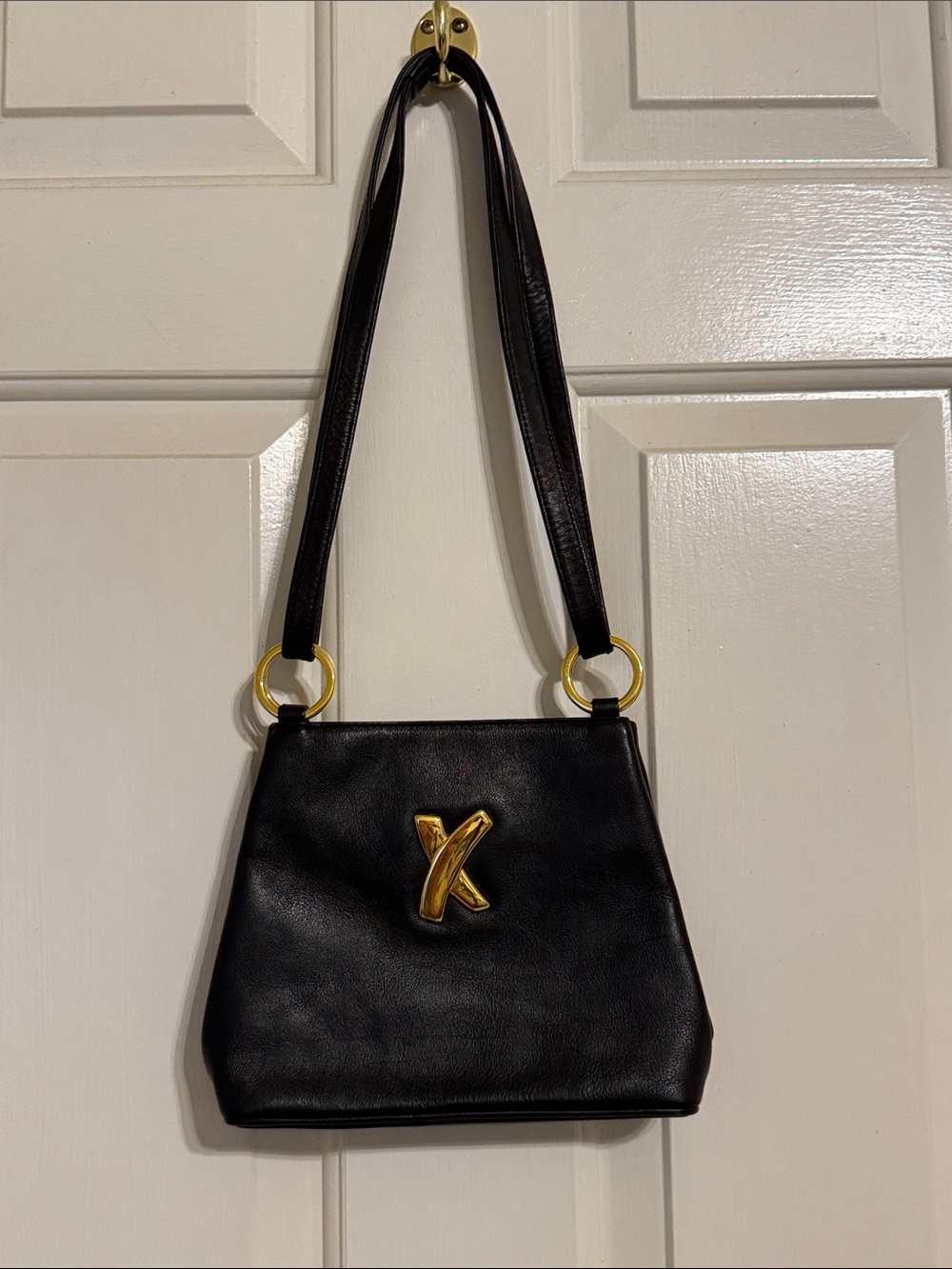 Black Leather Paloma Picasso small shoulder/evening Bag with Gold 'X' Accent.